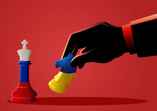 istock Man hand using a horse to fight against a king in chess game 1388378363