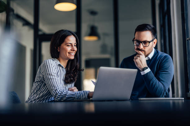 Portrait of two business colleagues, working online together. stock photo