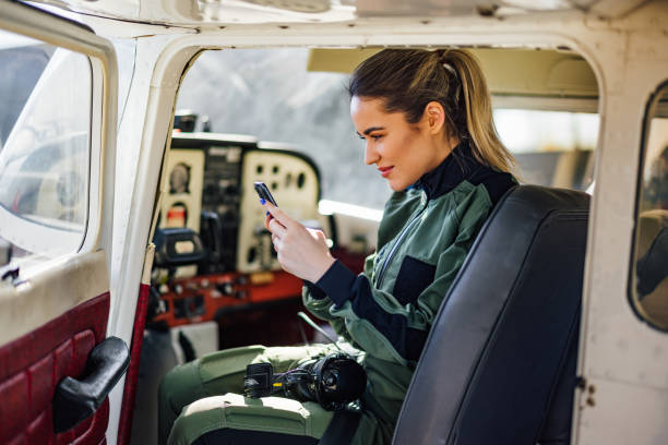 istock Joyful caucasian female skipper, reading messages on her smartph 1388379640