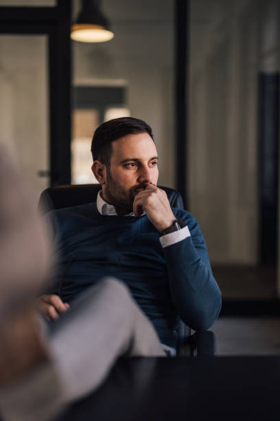 istock Thoughtful man, holding hand on his chin while looking around. 1388379722