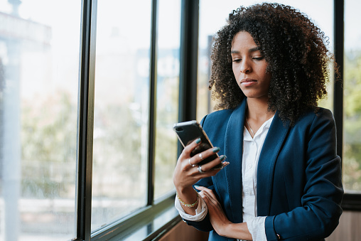 Portrait of a young businesswoman using smartphone