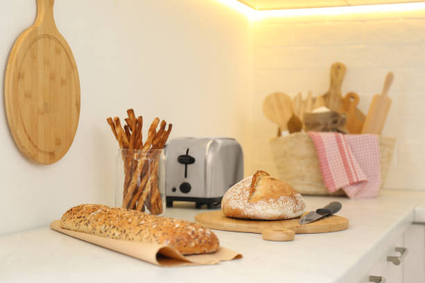 istock Loaves of bread and grissini on counter in kitchen 1388382533