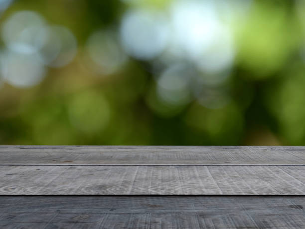 istock Plank counter with green forest bokeh blur background, concept, product presentation and advertisement, product promotion. 1388382669