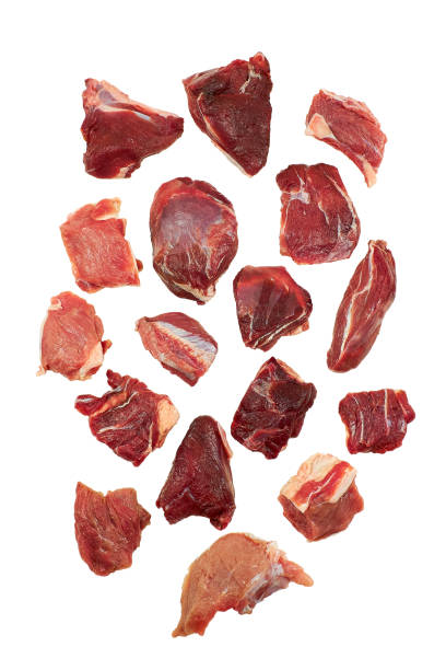 istock Pieces of raw meat isolated on white background 1388386207