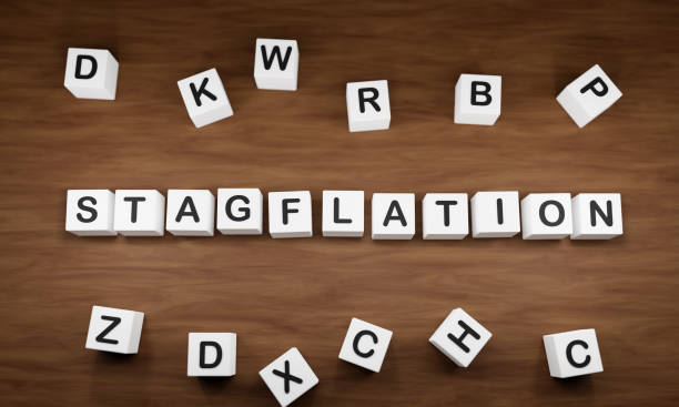 istock Stagflation. White dice with dark capital letters on a table. 1388387731