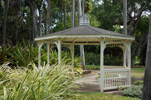 White pavilion among palm trees in Hawaii, USA.