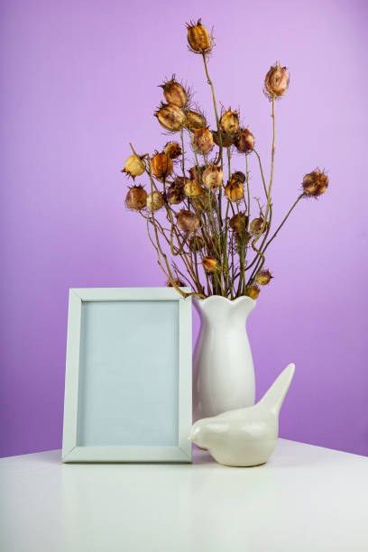 istock Cozy home desk table with vase with green branch 1388388848