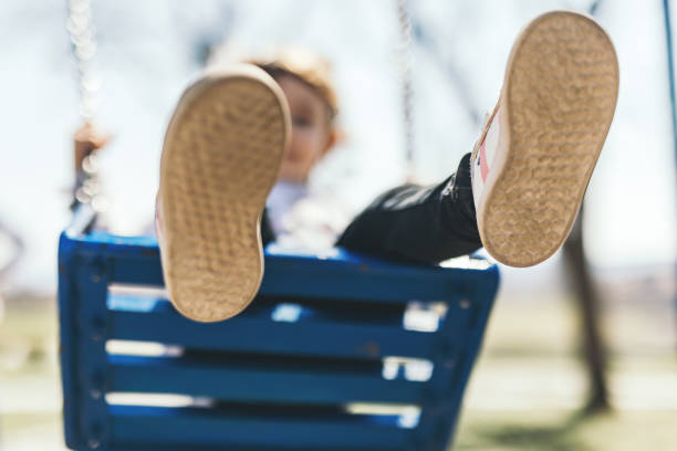 Little girl's shoes while swinging
