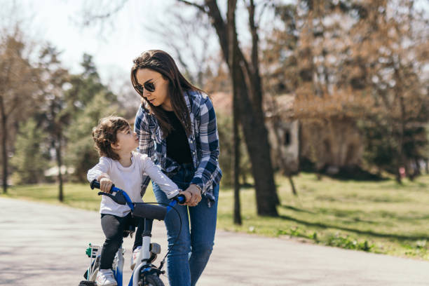 istock Mother teaching daughter how to ride bicycle 1388389238