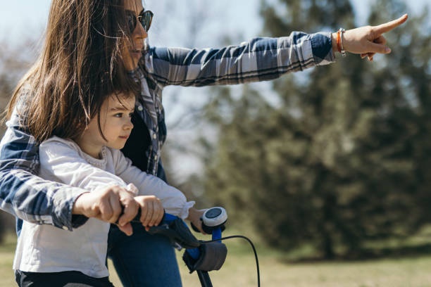 istock Cute little girl learning cycling 1388389252
