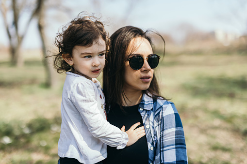 Little girl enjoys springtime with mother