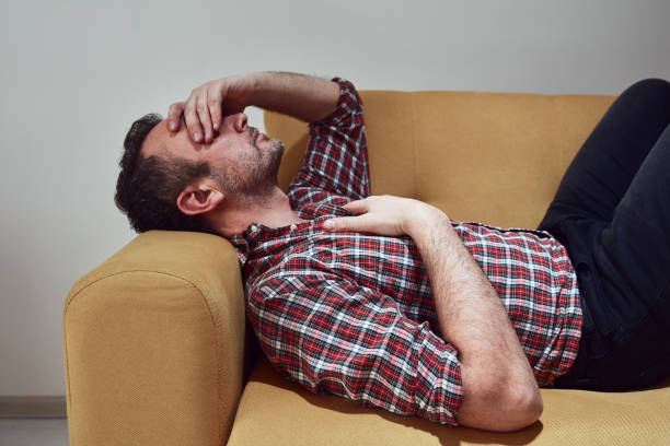 istock Man with headcahe pain at home. 1388389289
