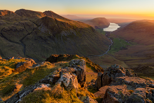 Epic views over Wastwater and Cumbrian Coast at sunset, seen from Great Gable Summit in the Lake District, UK.