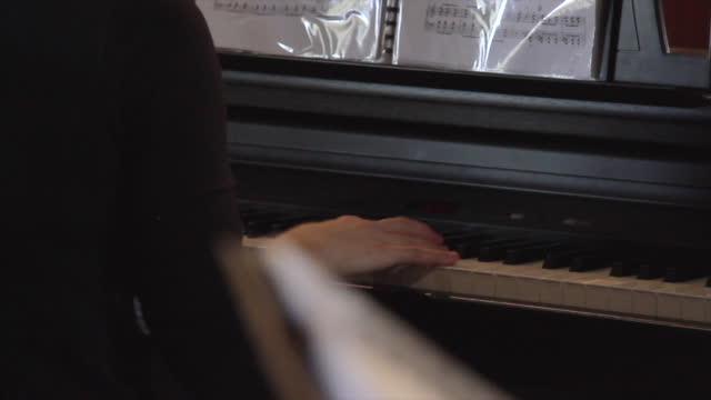 Pianist plays an old upright piano