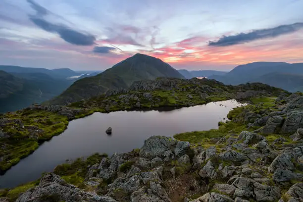 Late evening colours in sky seen from Haystacks Tarn, overlooking the Cumbrian Coast. Lake District, UK.