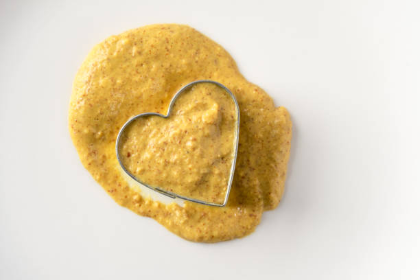 Spicy Brown Mustard in a Heart Shape stock photo