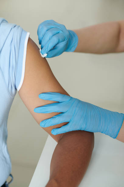 istock Nurse Wiping Arm of Patient 1388390871