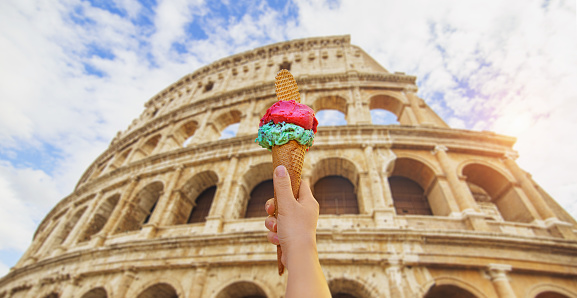 Colosseum in Rome, Italy during summer sunny day with italian ice cream gelato in the foreground.