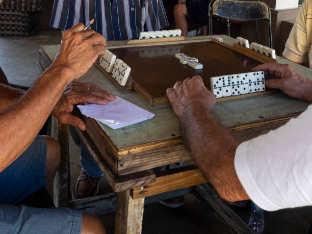 istock Closeup of Men Playing Dominoes 1388393425