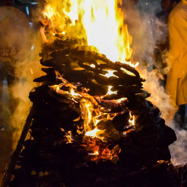 istock Fire flames on black background, Blaze fire flame texture background, Beautifully, the fire is burning, Fire flames with wood and cow dung 1388393810