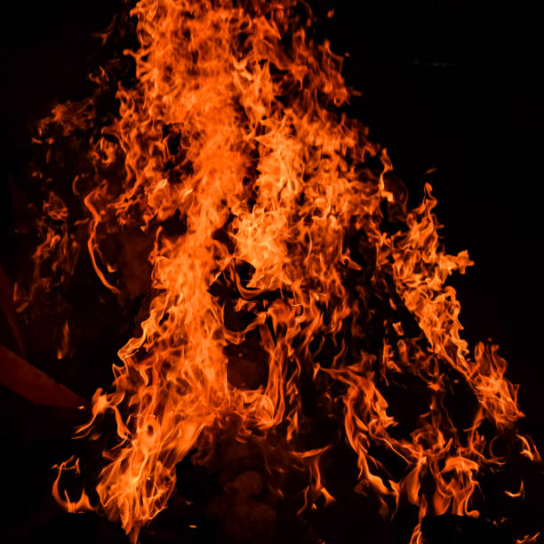 istock Fire flames on black background, Blaze fire flame texture background, Beautifully, the fire is burning, Fire flames with wood and cow dung 1388393811