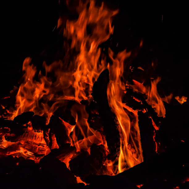 istock Fire flames on black background, Blaze fire flame texture background, Beautifully, the fire is burning, Fire flames with wood and cow dung 1388393837