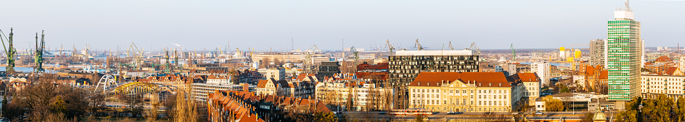 Panorama of Gdansk city centre and shipyard in a sunny day. View from above.