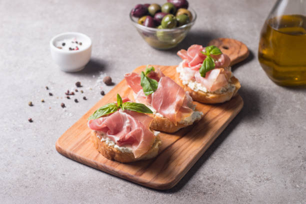istock Bruschetta with prosciutto, basil, olives, spices and herbs. Appetizers. 1388395391