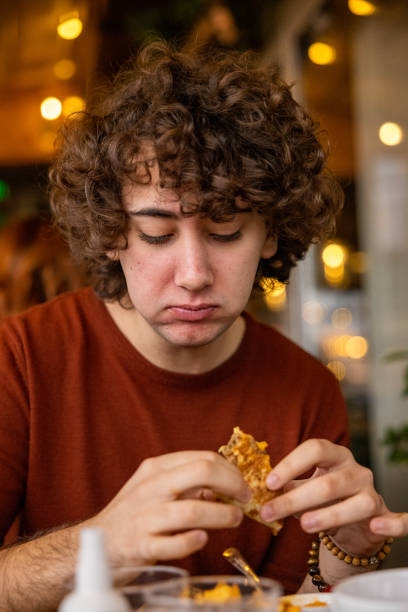 istock Young boy with curly hair having lunch 1388395498