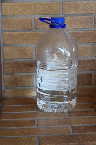 istock reused soft drink bottle with water 1388396179