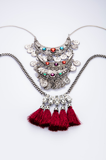 A stunning vintage-inspired necklace for women elegantly showcased on a white mannequin, exuding timeless charm and allure. This promotional photo captures the essence of a unique jewelry piece, perfect for an online jewelry store.