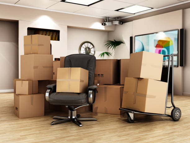 Cargo boxes standing at the middle of the office room. Office relocation concept stock photo