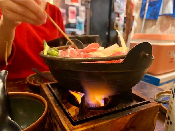 istock Nabe hotpot for dinner with female hand 1388398096