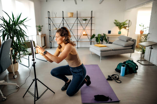 istock Woman vlogger exercising at home 1388398231