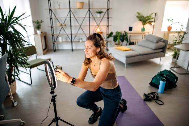 istock Woman vlogger exercising at home 1388398234