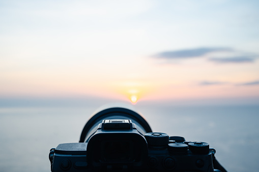 A camera was placed on the balcony to capture beautiful natural sea and mountain views, sunset scene. Selective focus.