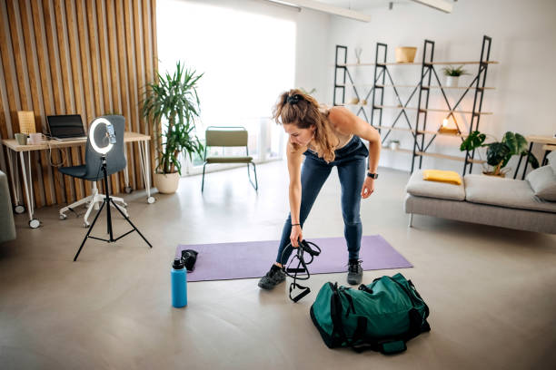 istock Woman vlogger exercising at home 1388398413