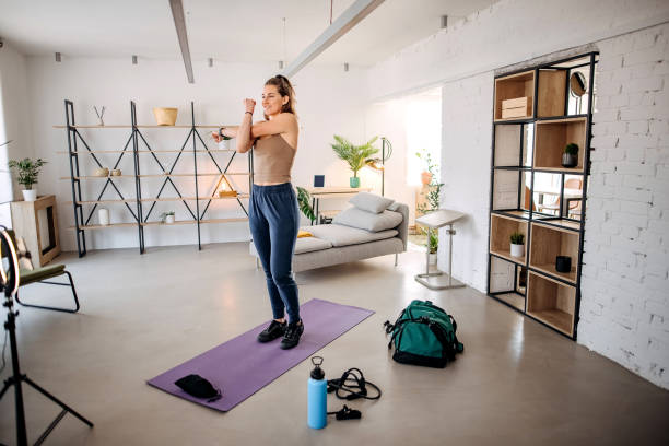 istock Woman vlogger exercising at home 1388398515