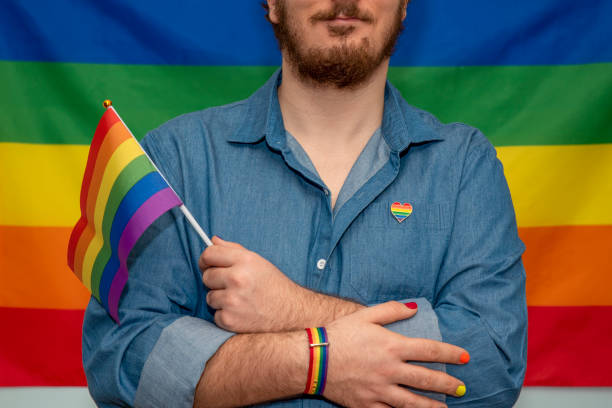 istock man holding lgtb rainbow flag 1388398535