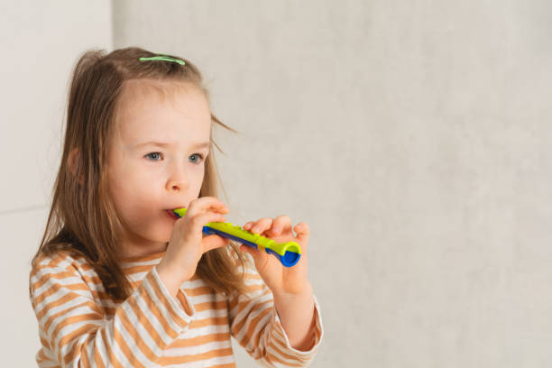istock Child at home learning to play musical instruments 1388398547
