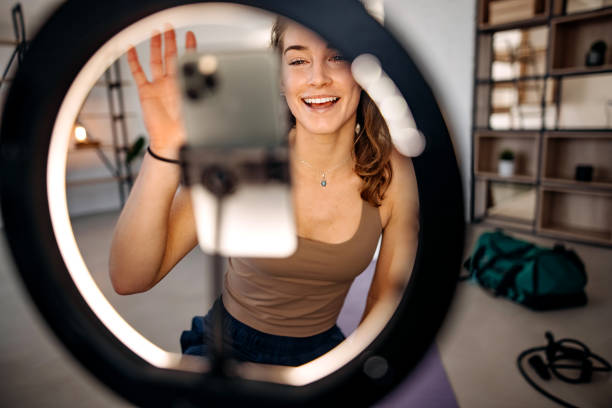 istock Woman vlogger exercising at home 1388399310