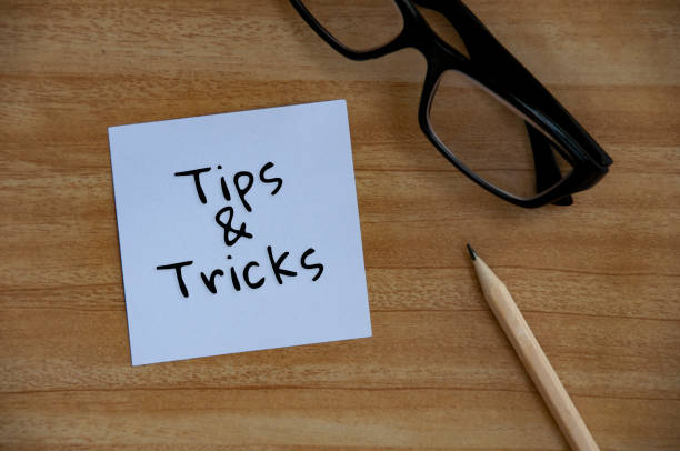 istock Tips and tricks text on white notepad with glasses and pencil background. 1388401854