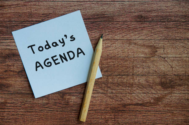 istock Today's agenda on white notepad with wooden table background. 1388401855