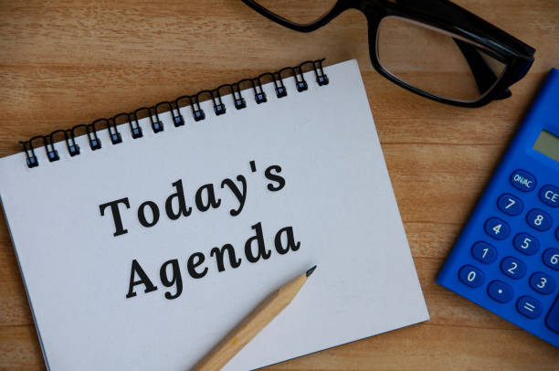 istock Today's agenda text on notepad. Glass, pencil and calculator background. 1388401891