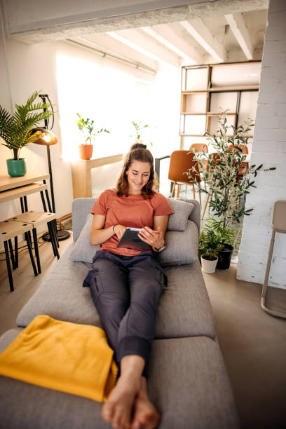 istock Pretty woman using tablet at home 1388402067