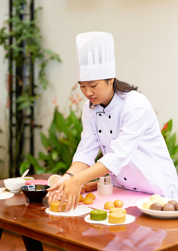Female Chef Making Chinese Moon Cake In The Garden