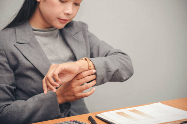 istock Time out concept. Urgent work, business woman seeing wrist watch and using mobile phone before meeting. Smart woman check the schedule before going to the office. Time out for appointment meeting 1388402641