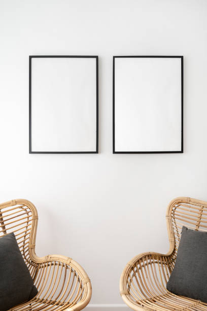 istock Blank space picture frame over wicker rattan armchairs 1388403975