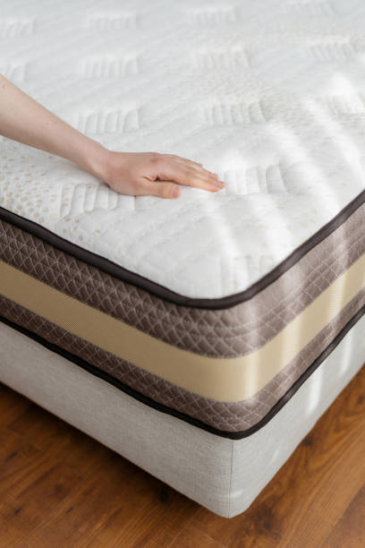 istock Woman hand pressing on polyurethane material on mattress 1388404024
