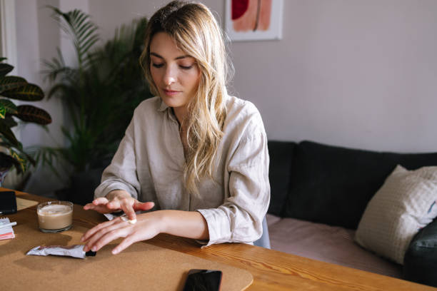 istock Blonde Woman Applying Hand Cream 1388404029